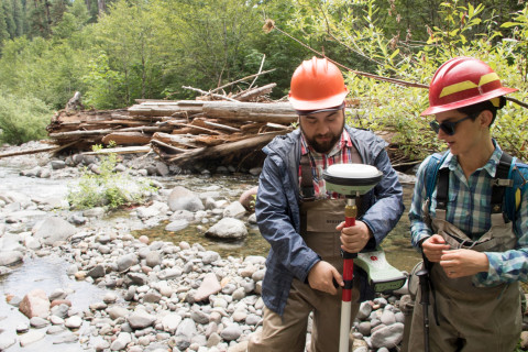 (L to R) Alberto Paredes, visiting researcher from Universidad Austral de Chile, Valdivia, Chile, and Arianna Goodman, graduate student OSU, holding a Real Time Kinematic (RTK) GPS receiver to make precise measurements of positions in the stream.