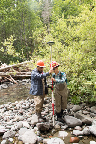 (L to R) Alberto Paredes, visiting researcher from Universidad Austral de Chile, Valdivia, Chile, and Arianna Goodman, graduate student OSU, holding a Real Time Kinematic (RTK) GPS receiver to make precise measurements of positions in the stream