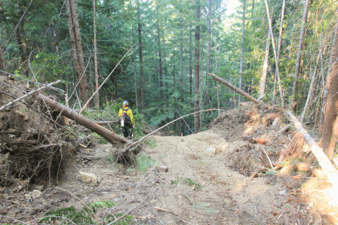 This was an accidental beginning of the dozer line at junction with 465 road. Operator likely mistook this for the main side ridge. After opening ca. 60 feet the dozer backtracked and began the actual fire line running down side ridge to road 455.