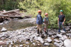 (L to R) Alberto Paredes, visiting researcher from Universidad Austral de Chile, and Arianna Goodman, grad student OSU, converse with USFS Hydrologic Technician Greg Downing on the location & history of stream cross-section locations in Lookout Creek